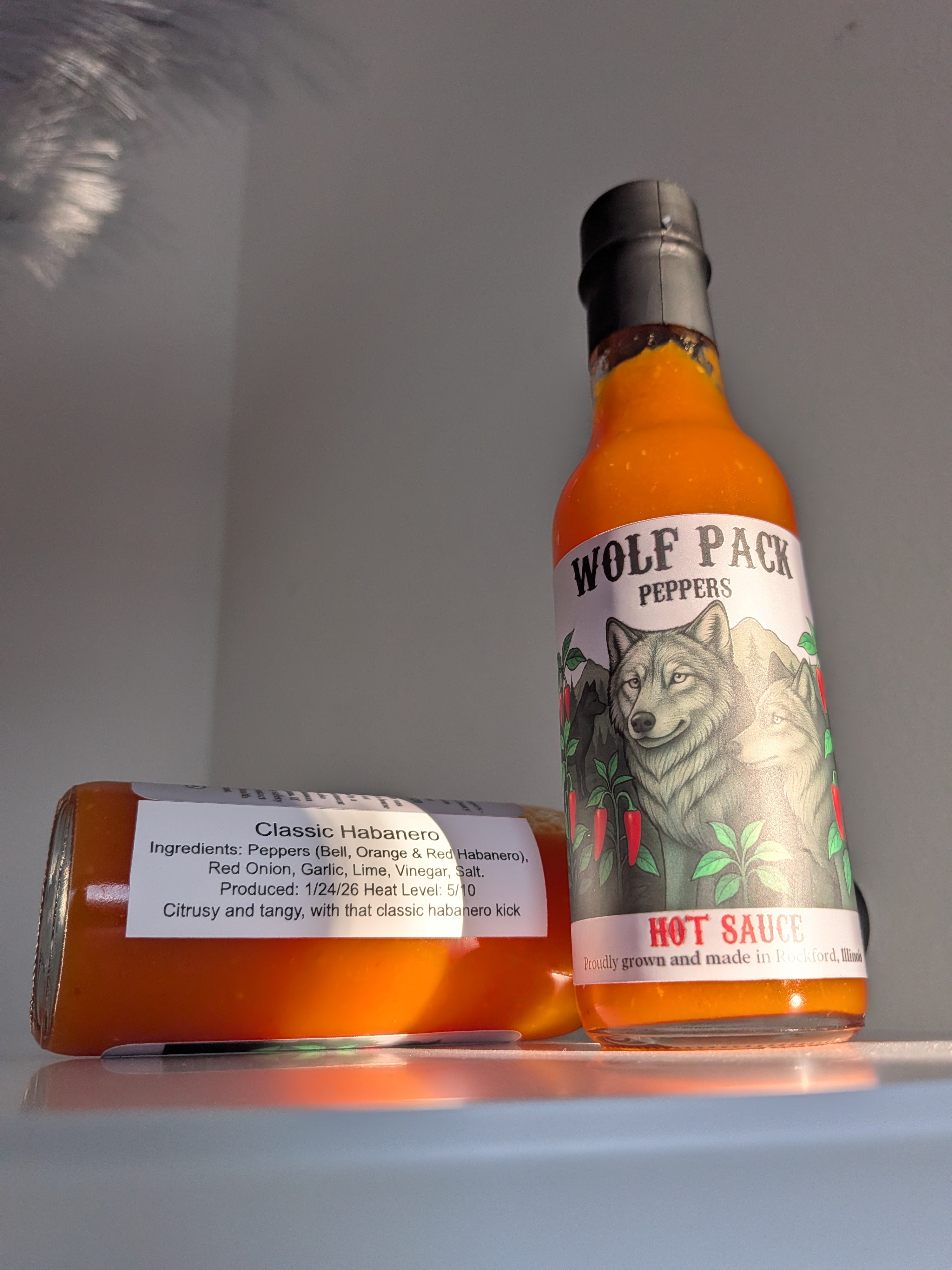 Two bottles of Wolf Pack Peppers Classic Habanero hot sauce