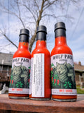 Three bottles of Wolf Pack Peppers Lasting Impression hot sauce